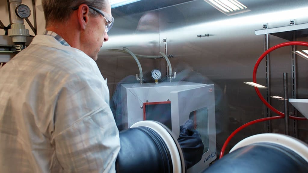 Materials science expert working with machine.