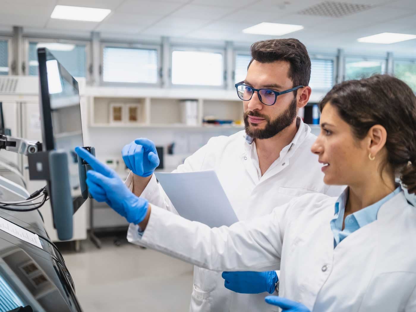 Diverse Lab Technicians Analyzing Data Together