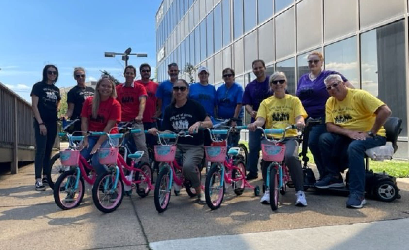 UTRS corporate employee group photo showing the bikes made for Foster Kids.