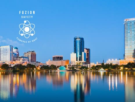 Orlando Skyline at Dusk seen from Lake Eola with Fuzion Safety logo in all white in top left corner.